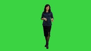 young asian women standing and talking to a camera on a green screen chroma key