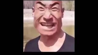 square head chinese man tries to sing but fails