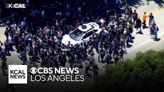 Hundreds of skateboarders roll through Downtown LA for "Go Skateboarding Day"