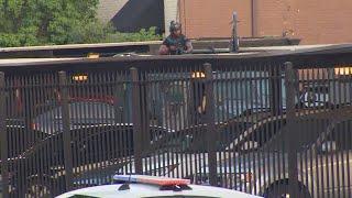 Dallas police in standoff with suspect firing shots near SMU