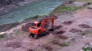 Digging deep: Crane Excavation in Tough silt at dam Downstream.