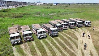 Huge Construction 12 Wheel Dump Truck Unloading Dirt Filling Up Land Bulldozer KOMATSU D53P Working