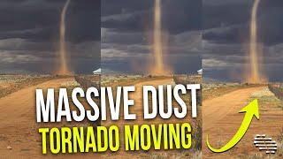 Massive Dust Tornado Moving in the Horizon as Lady Talks to a Guy in the Background