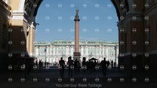 Tourists walk through the arch of the general staff to the Palace square in the summer