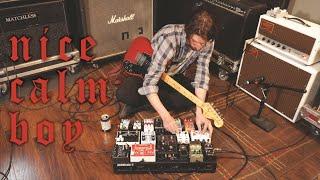 nice calm boy plays the pedalboard instead of the guitar