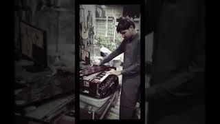 Blind man playing harmonium and singing at Saleem and sons music house 