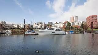 luxury yachts on tranquil water near downtown of portland in blue sky. timelapse 4k