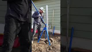 NW Quik Pull pulling a metal fence post with concrete footing.