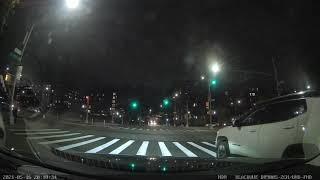 Scooter runs red light driving into oncoming traffic.