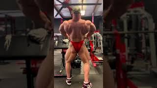 Big muscle daddy Josh Manley posing in red trunks