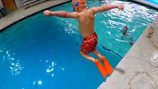 Cute Kids Jumping into the Pool at Scuba Adventure