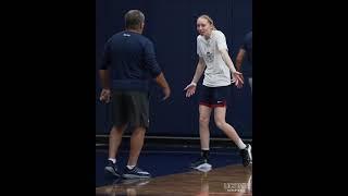 Paige Bueckers playfully arguing with Geno Auriemma