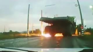 Large Dump Truck drives into high voltage power line, and tires explode.