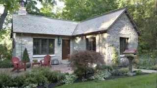 Old 1900's log gatehouse reinvented as an English-style Limestone cottage in Minnesota