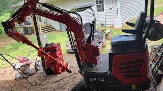 Installing a heavy-duty auger on a Chinese mini excavator.