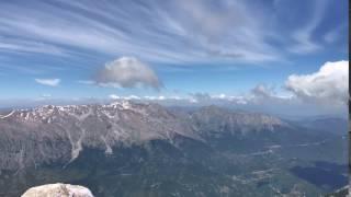 Time-lapse of clouds traveling over mountains