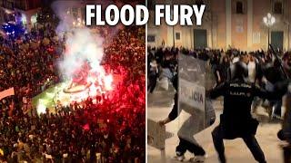 Riot cops clash with raging protesters hurling flares in Spain as anger erupts over flood deaths