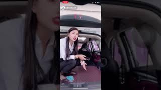 Chinese girl show her black nylon feet in car