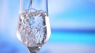 water pouring into glass slow motion fresh natural cool with bubbles