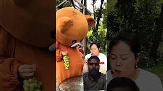 The girl ate grapes from the panda!