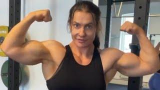 Beautiful muscular woman flexing big biceps