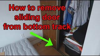 how to remove sliding closet door from bottom track (plastic guides)