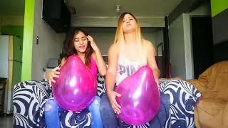 Fun and wild balloon busting by two lovely gals