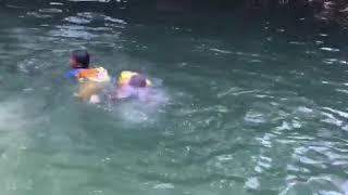 Cute indian village boy swimming training