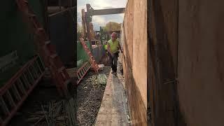 Taking form liner off a concrete wall.