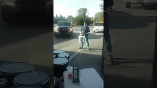 snare drumming in busy parking lot