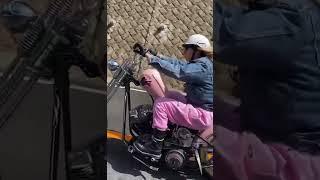 Biker girl on her classic Harley-Davidson motorcycle chopper