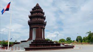 Grilled Stuffed frogs with kroeung and my wife and  I at the Independence Monument Battambang city