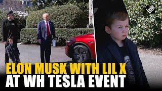 Elon Musk with son, little X at White House Tesla event, son listens Pres Trump with full attention