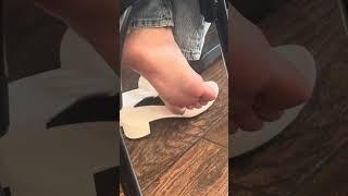 Candid Latina feet in restaurant