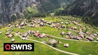 First-time paraglider captures STUNNING footage of historic Swiss village | SWNS