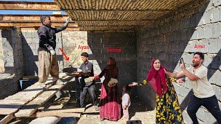 Ayas and Fateme covering the roof of the house with the help of the operator(Kohrig family)