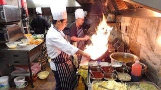 The Heat of the Indo-Chinese Wok Master's Kitchen on a Very Busy Saturday Night in Indian Restaurant