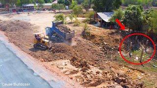 Small team work!! Dozer pouring soil delete pit connect road process with dump trucks unload