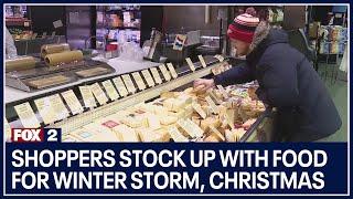 Shoppers stock up with food for winter storm, Christmas