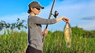 Fishing in a Ukrainian village, Ukrainian girl cooks fish soup and fried fish