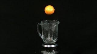 Blending an Orange Slow Motion into a Blender in High Definition HD Slow Mo Video Camera Action Shot