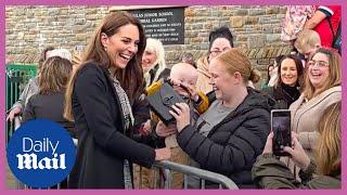 Kate Middleton laughs as adorable baby swipes her handbag