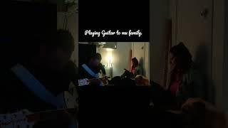 In the cozy corner - Playing guitar to my family.