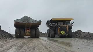 How is a day of work in a mine driving trucks? Dump trucks driving into an open-pit mine