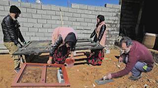 Finishing the cementing house;painting the doors and windows by the young couple‍️‍