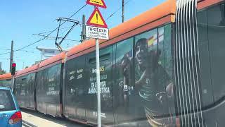 Athens Line 7 tram with bet365 ad arriving at Lampraki station