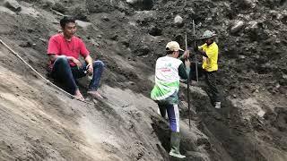 the driver helped the miners dig up the sand and load it into the truck and he slipped on the cliff!