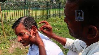 Roadside ear cleaner at the Cricket Ground, Kolkata