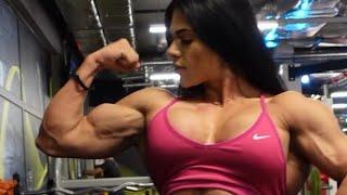 Beautiful muscular woman flexing big biceps