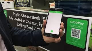 GrabPay SEA managing director Jason Thompson uses the Grab app to pay for food